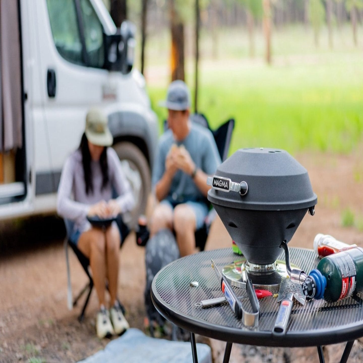 A group of people sitting outside with magma products