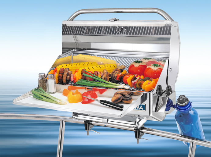 Newport Classic Rectangular grill mounted on boat with grilled skewers and vegetables
